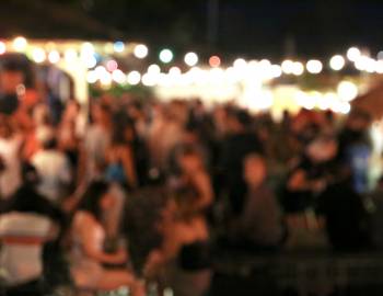blurry image of people at an evening outdoor festival