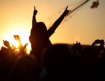 concert audience silhouette at sunset