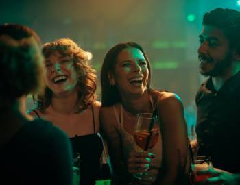 people laughing in a bar