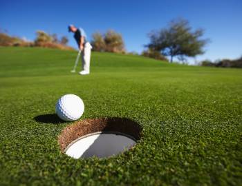 golf ball going into hole