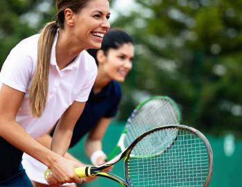two women playing tennis