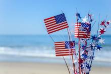 bouquet of american flags with beach in the background