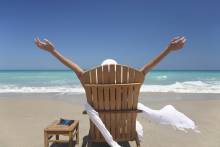 woman with outstretched arms on a beach in Florida