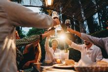 group of friends cheers wine glasses at a restaurant