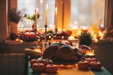 Table set for thanksgiving you can see candles and the turkey on the table