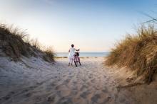 Woman biking on the beach