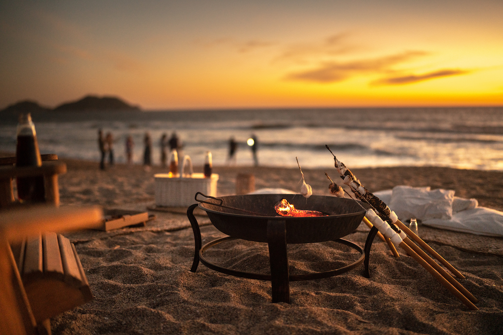 fire pit on beach at sunset