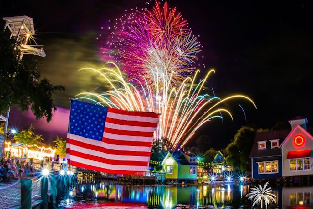 American Flag and fireworks over a lagoon