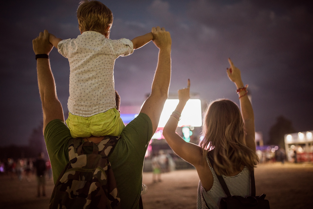 family at outdoor concert at night